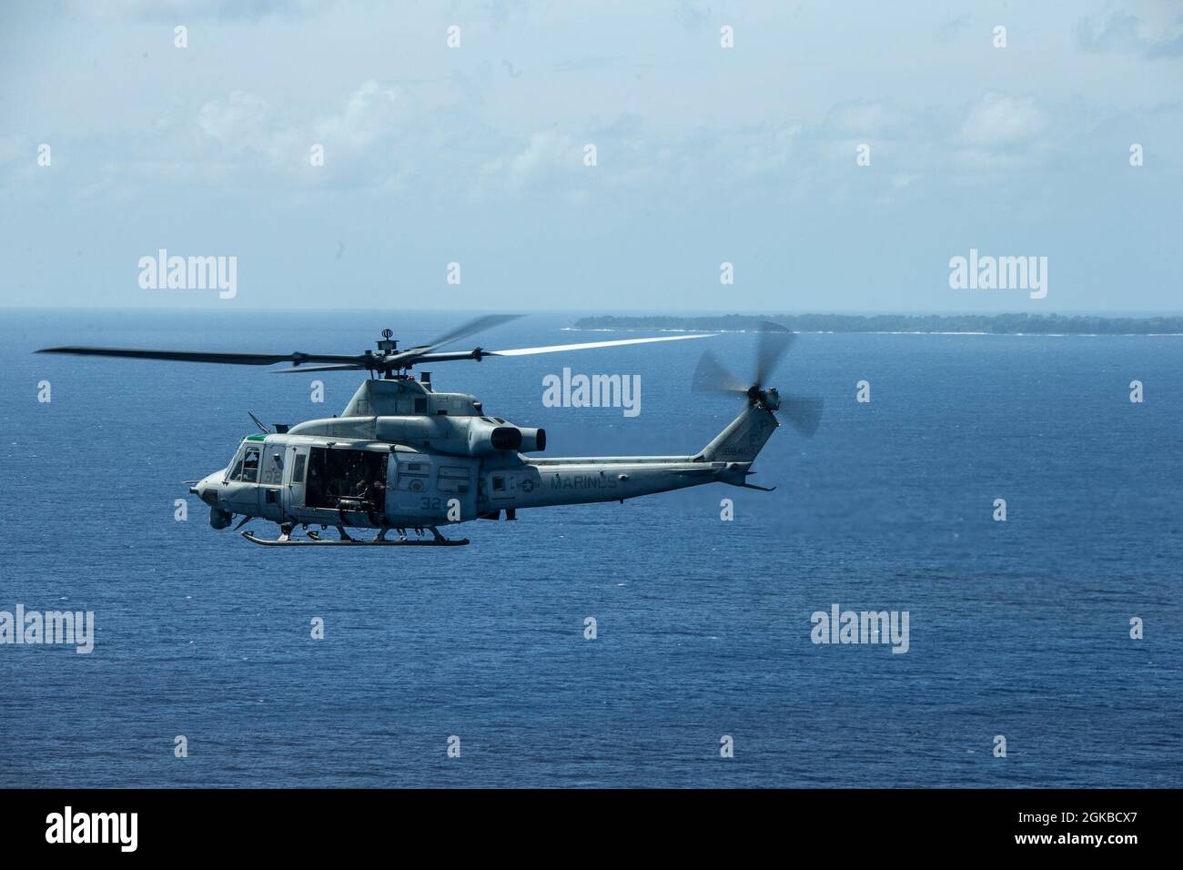 A U.S. Marine Corps UH-1Y Huey with Marine Medium Tiltrotor Squadron 262 (Reinforced), 31st Marine Expeditionary Unit (MEU), flies above Palau after departing from USS New Orleans (LPD 18) on its way to the island of Peleliu, March 3, 2021. The 31st MEU is operating aboard ships of the Amphibious Squadron 11 in the 7th fleet area of operations to enhance interoperability with allies and partners and serve as a ready response force to defend peace and stability in the Indo-Pacific region. Stock Photo