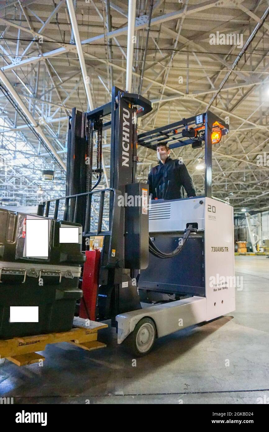 YOKOTA, Japan (March 3, 2021) – Logistics Specialist Seaman Jacob Wright operates a forklift, routing cargo for its prospective bay onboard NAVSUP Fleet Logistics Center Yokosuka, Navy Overseas Air Cargo Terminal Yokota. Stock Photo