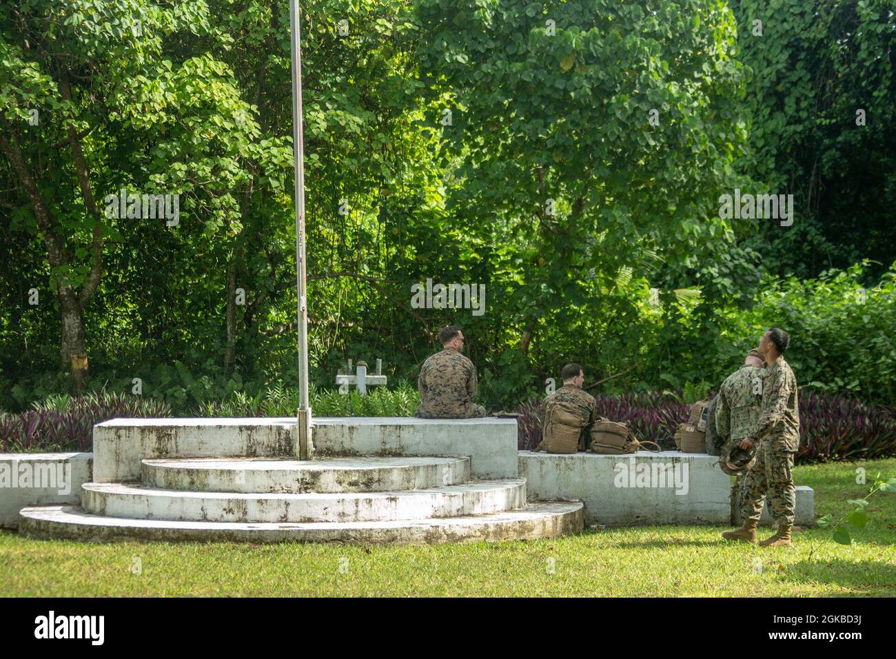 U.S. Marines and Sailors with the 31st Marine Expeditionary Unit (MEU) pay their respects at a memorial built to honor the Soldiers of 81st U.S. Army Infantry Division who fought during World War II on the Island of Peleliu, Republic of Palau, March 3, 2021. The 31st MEU is operating aboard ships of the Amphibious Squadron 11 in the 7th fleet area of operations to enhance interoperability with allies and partners and serve as a ready response force to defend peace and stability in the Indo-Pacific region. Stock Photo