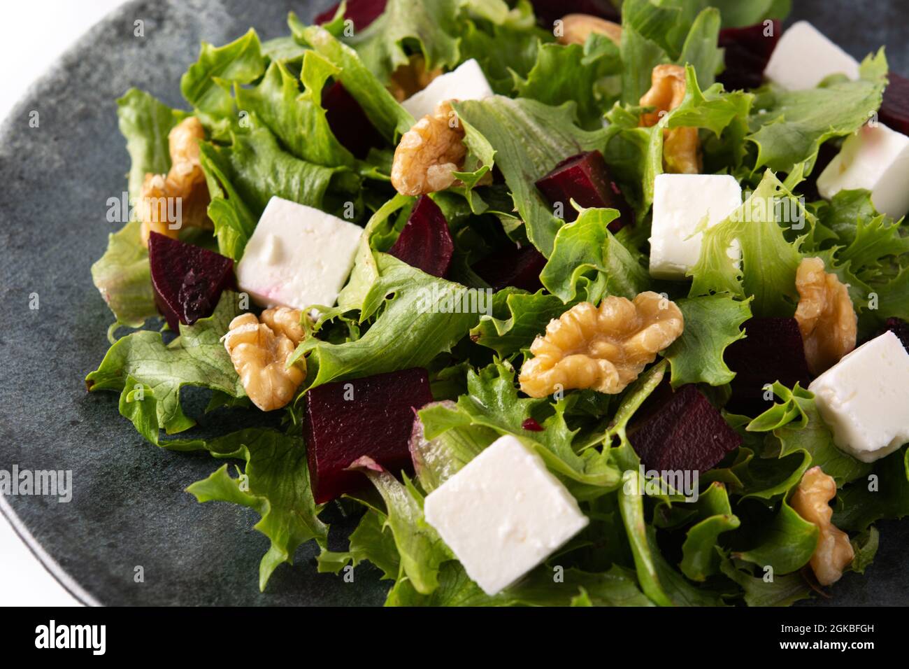 Beetroot salad with feta cheese,lettuce and walnuts isolated on white background Stock Photo
