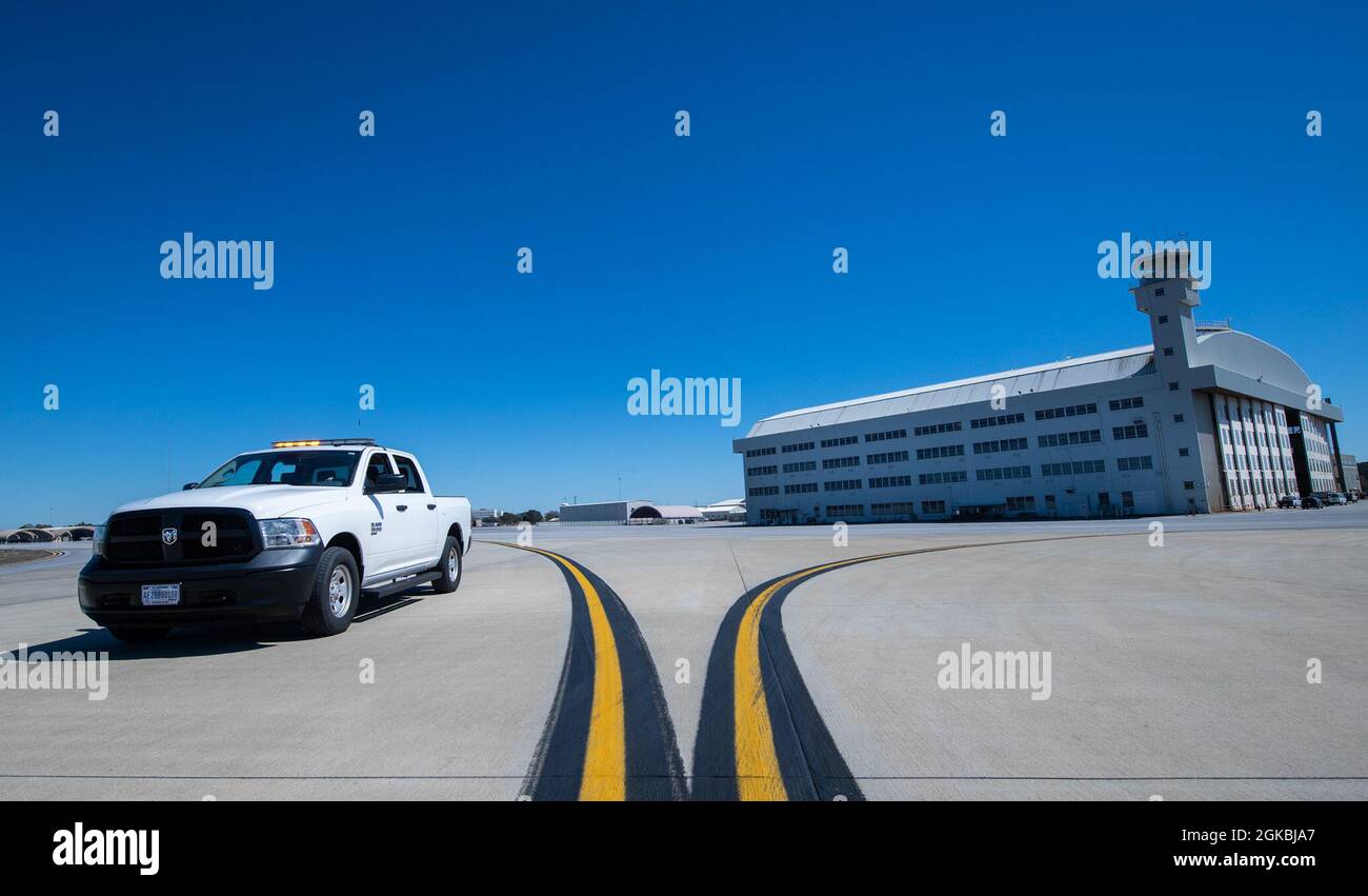 An Airfield Management vehicle rolls past King Hangar at Eglin Air