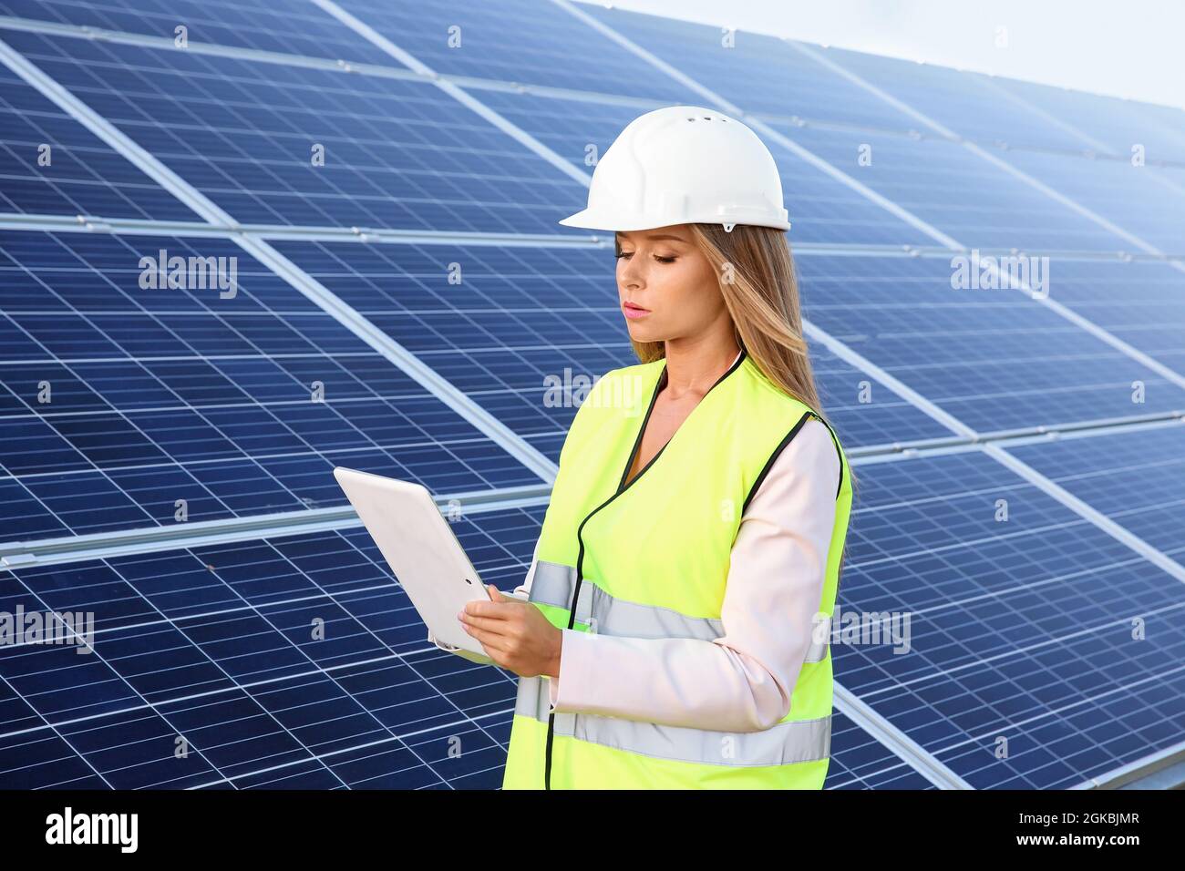 Female engineer developing project on installation of solar panels ...