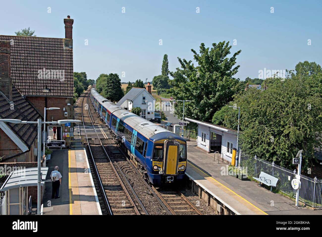 BR class 377 electric multiple unit passes through the down platform at  Wye railway station in Kent, UK Stock Photo