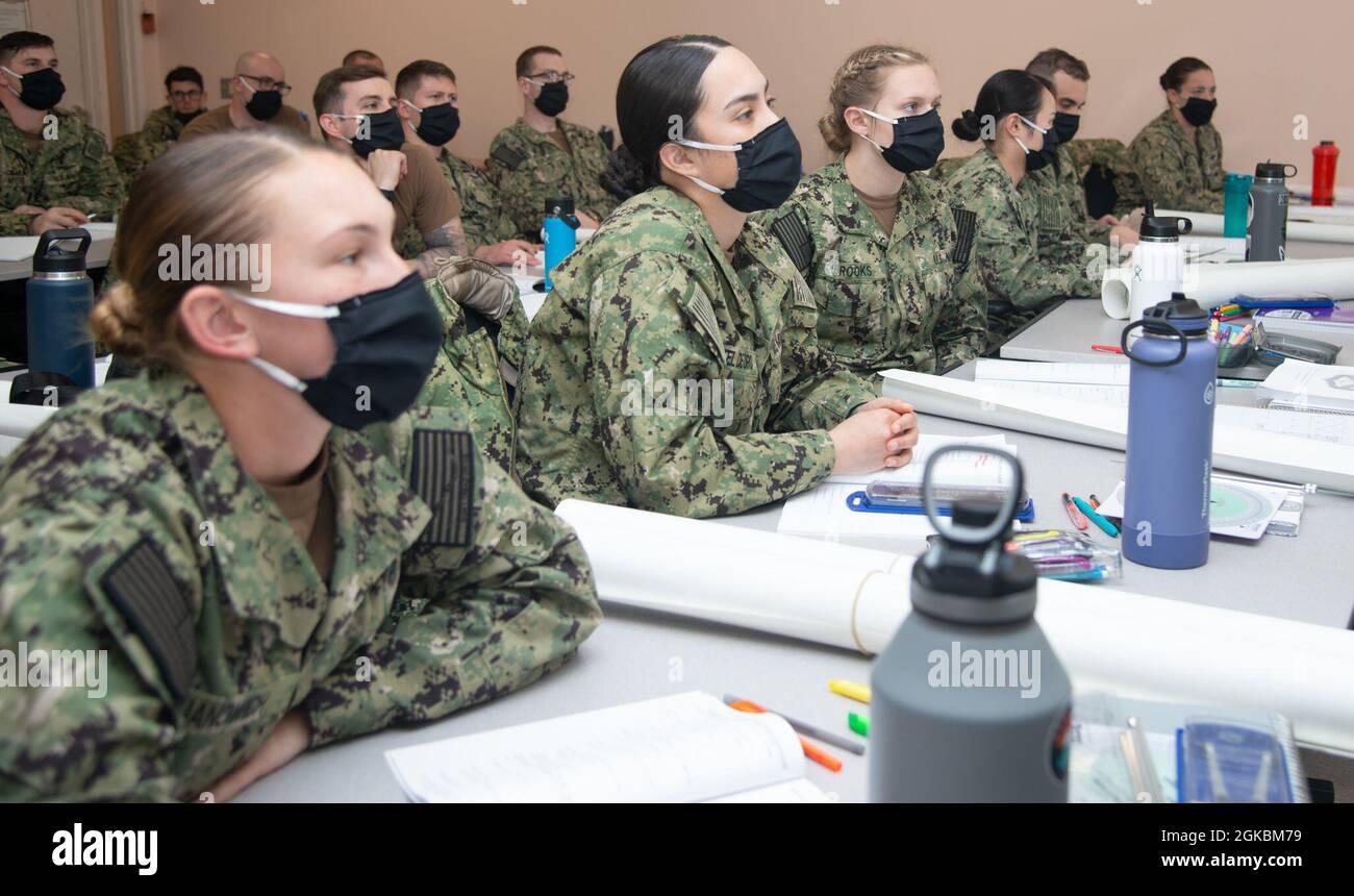 210305-N-EL867-0010 NEWPORT, R.I. (March 5, 2021) Naval Science Institute Seaman-to-Admiral (NSI/STA21) class 20010 students at Officer Training Command Newport (OTCN), R.I., listen during a class on compasses and navigational equipment, March 5. NSI/STA-21 is an eight-week course of intense officer preparation and indoctrination for petty officers and chief petty officers, with course enrollment timed to allow college entrance during summer or fall semesters after selection. Stock Photo