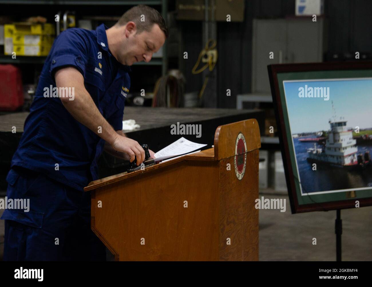 Cmdr. Paul Mangini, commander of the U.S. Coast Guard Marine Safety Unit, Huntington, stamps the Certificate of Inspection to the MV Kenneth Eddy at the Marietta Repair Station in Marietta, Ohio. Stock Photo