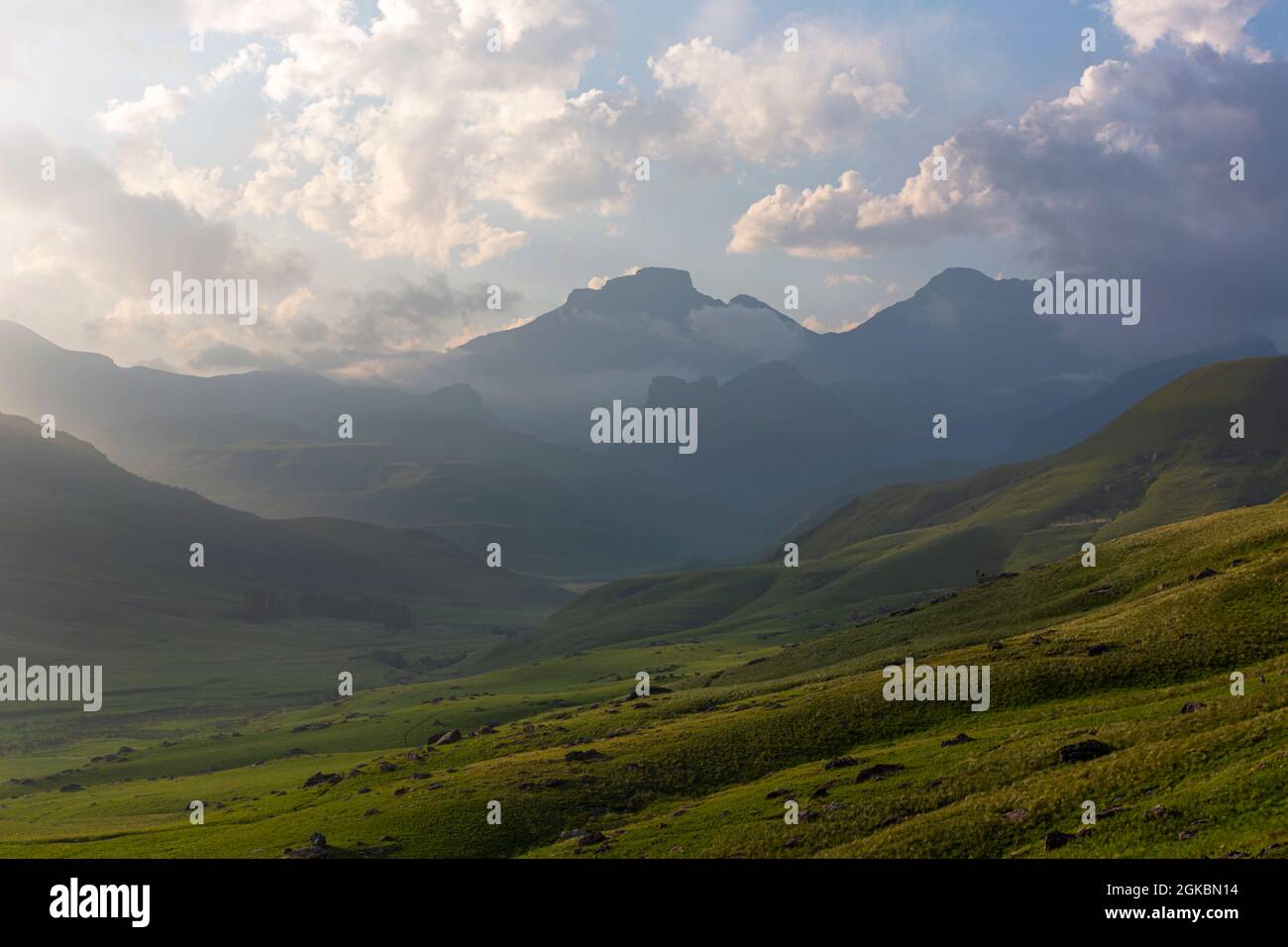Low clouds in the late afternoon in the green valley Stock Photo - Alamy