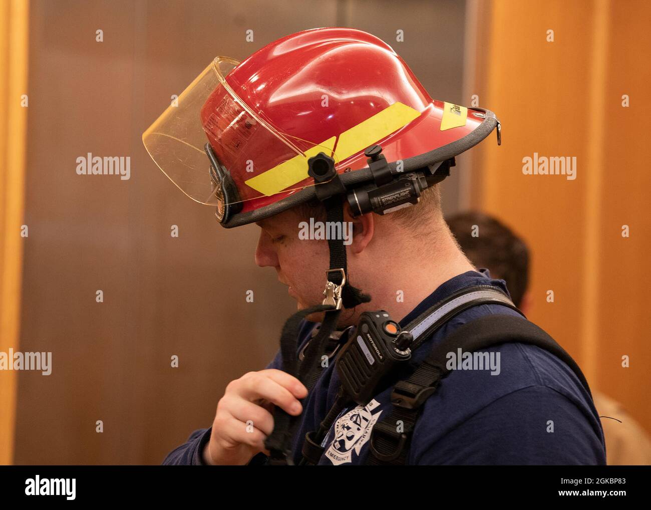 U.S. Air Force Staff Sgt. John Cools, 8th Civil Engineer Squadron firefighter crew chief, takes off firefighting equipment after a successful firefighting readiness exercise at Kunsan Air Base, Republic of Korea, 5 March 2021. Regular Debriefs after firefighting exercises are necessary to ensure teams retain valuable information. Stock Photo