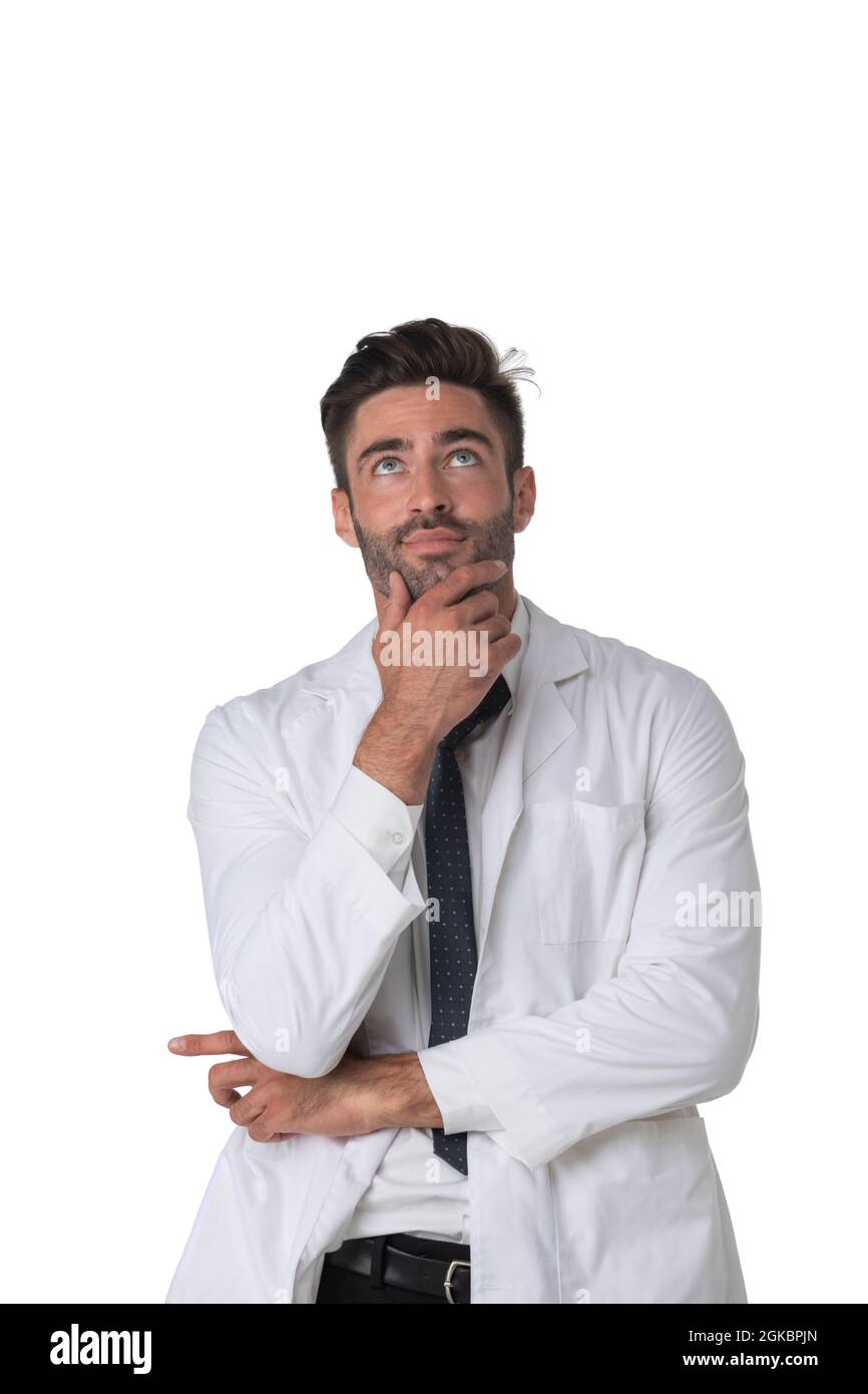 Young doctor surgeon man over isolated white background with hand on chin thinking about question, pensive expression. Doubt concept. Stock Photo