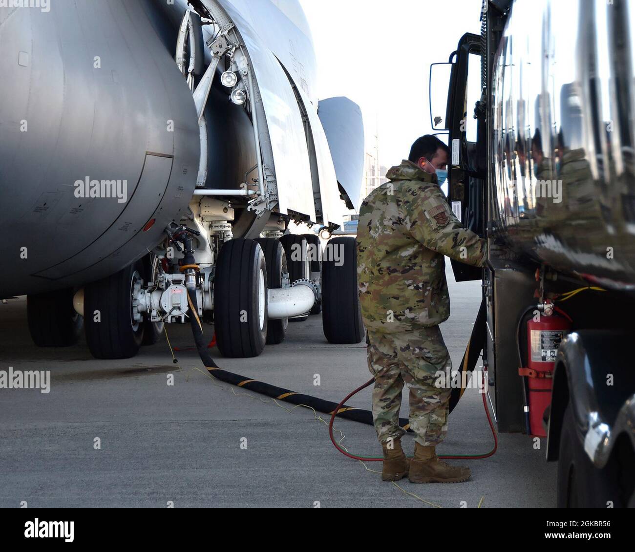 SELFRIDGE AIR NATIONAL GUARD BASE, Mich.-- Senior Airman Nick Bousquette, fuels distribution operator, 127th Fuels Management Flight based here, monitors the volume of fuel he's pumping into an active duty C-5 Galaxy on March 6, 2021. The C-5 was here from Dover Air Force Base, Delaware, for training with the Michigan Army National Guard, highlighting the interoperability of joint services here at Selfridge. Stock Photo