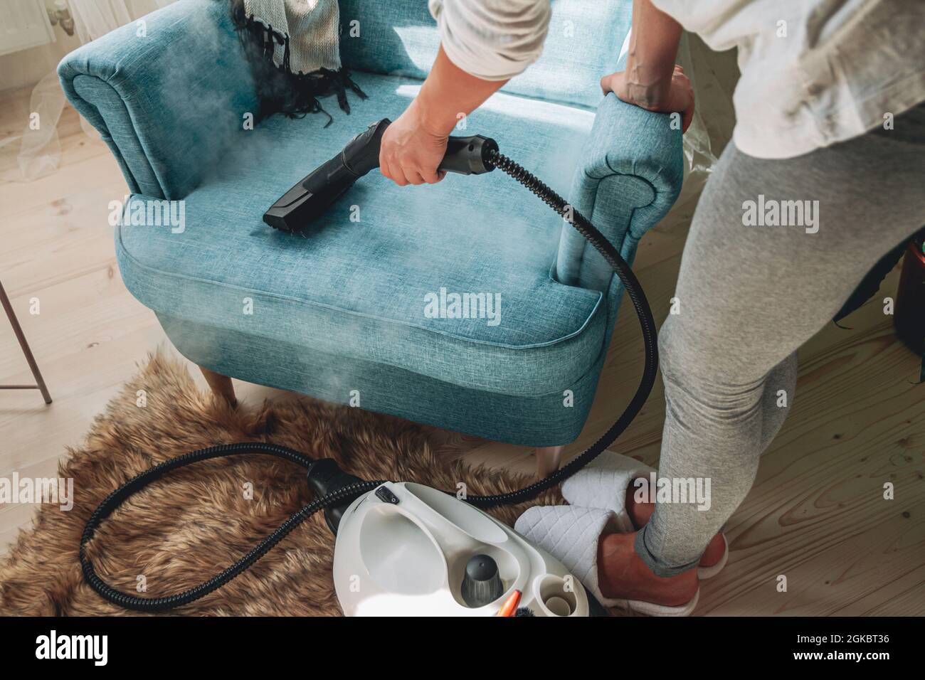 Hand cleaning a armchair with steam cleaner, Home cleaning conce Stock