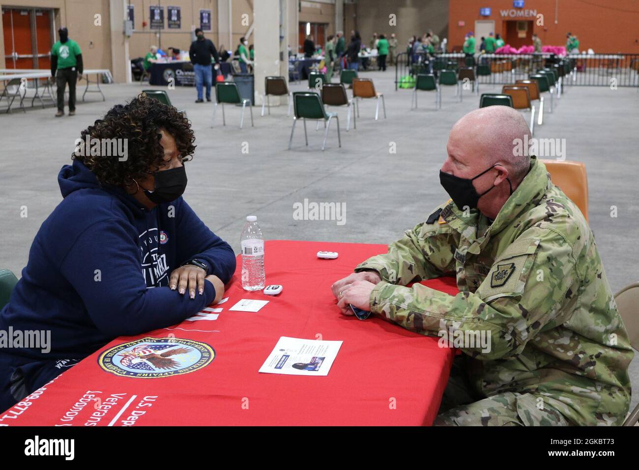 Maj. Gen. Mark Schindler (right), Pennsylvania’s acting adjutant general, speaks with one of the veterans who attended the YWCA of Greater Harrisburg's Homeless Veterans Stand Down on March 6, 2021, at the Pennsylvania Farm Show Complex in Harrisburg, Pa. The Pennsylvania National Guard has partnered with the YWCA for 15 years, hosting this annual event to help local veterans. Stock Photo