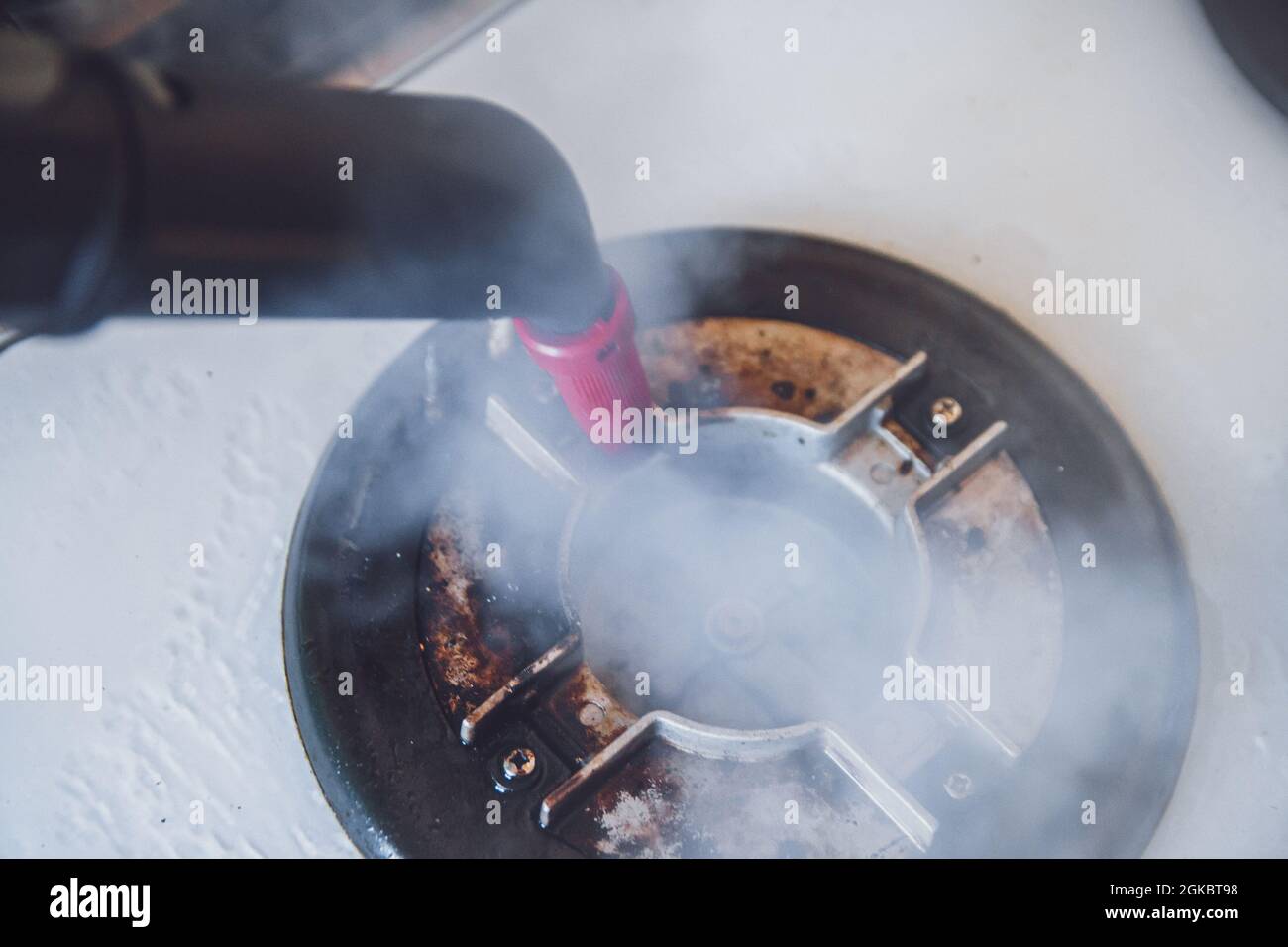 Glass ceramic stove cleaning with a steam cleaner, house disinfe Stock