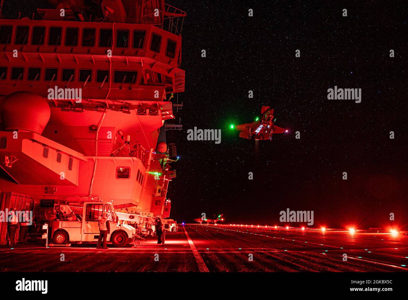 WESTERN ATLANTIC OCEAN (March 7, 2021) F-35 test pilots U.S. Marine Maj. Brad Leeman, BF-05, and British Royal Navy Lt. Cmdr. Barry Pilkington, BF-19, performs night lighting evaluation flights in F-35B short takeoff and vertical landing (STOVL) variants of the jet aboard Italian aircraft carrier ITS Cavour (CVH 550). The Air Test and Evaluation Squadron (VX) 23 pilots are embarked with the F-35 Patuxent River Integrated Test Force (ITF) for sea trials on the Italian Navy flagship here. Cavour is in phase one of its “Ready for Operations” campaign to certify its use of the fifth-generation fig Stock Photo