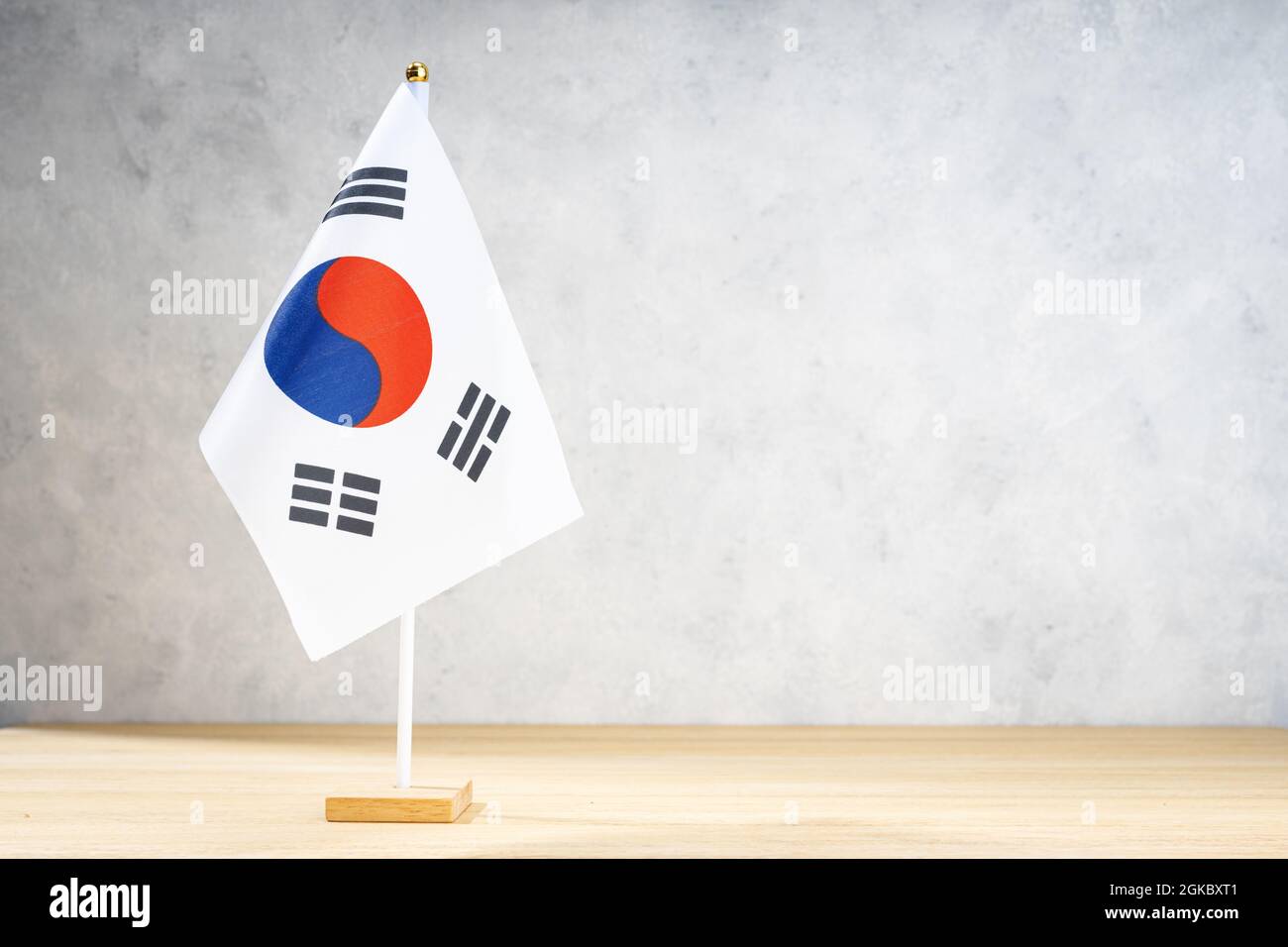 South Korea table flag on white textured wall. Copy space for text, designs or drawings Stock Photo