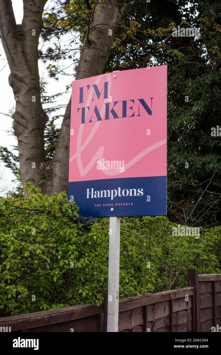 Hamptons estate agent's sold sign, Epsom, Surrey, UK Stock Photo