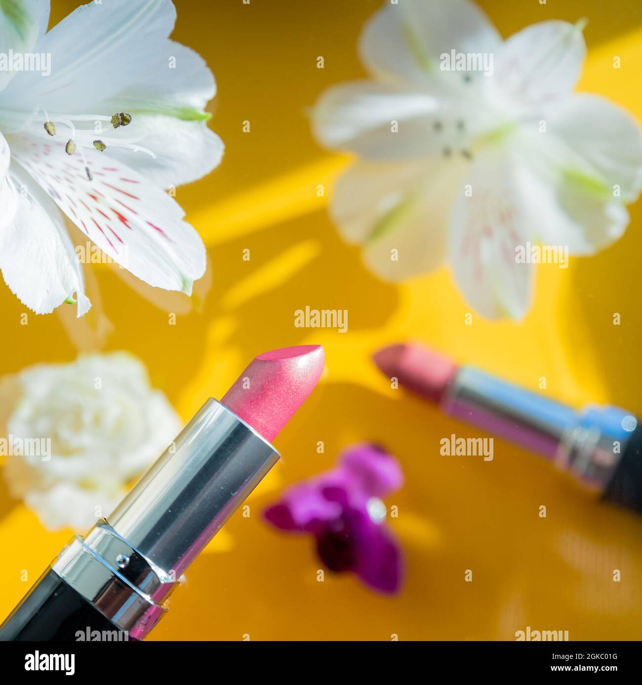 Flat lay composition with lipstick and roses on color background Stock Photo