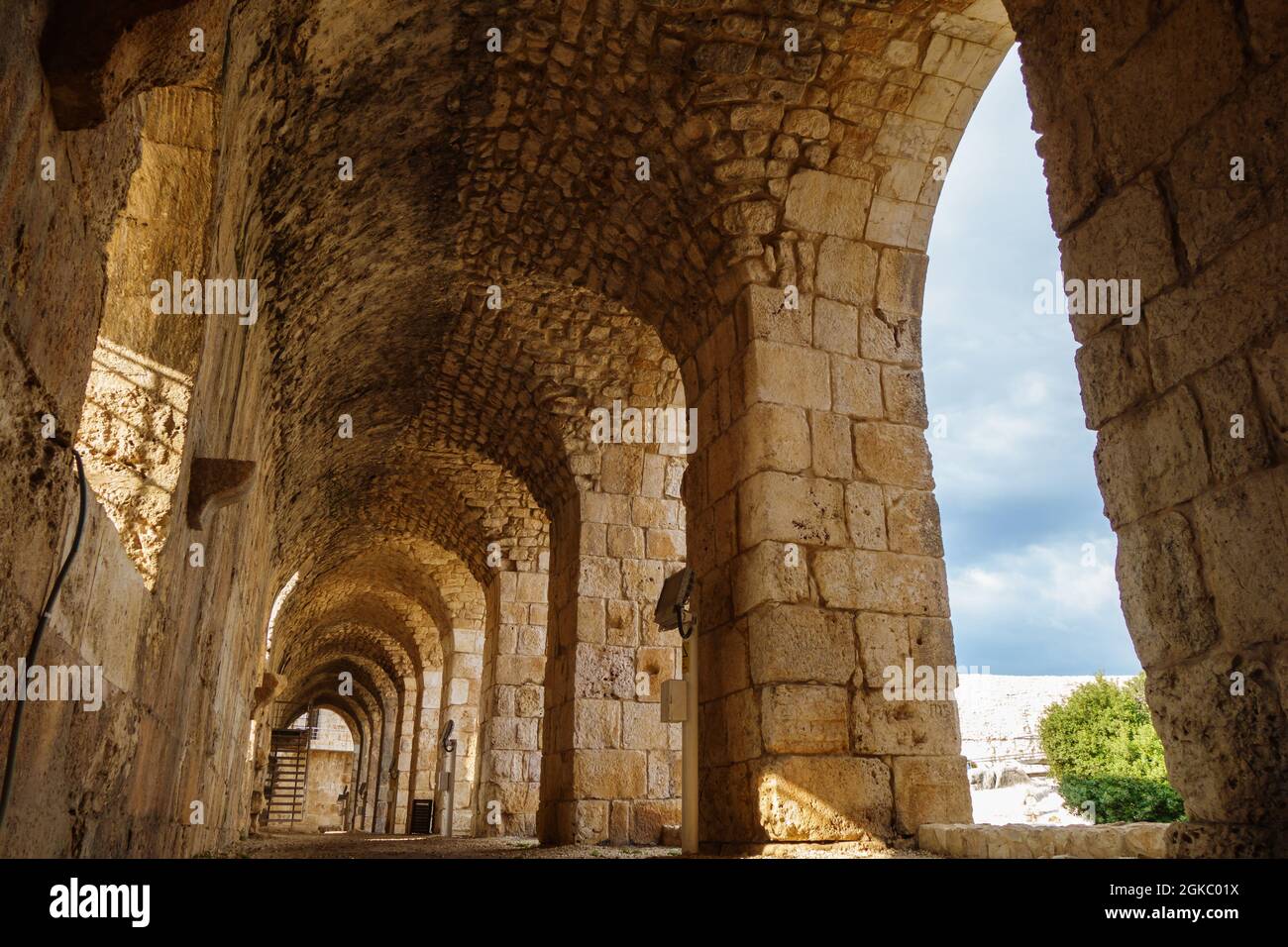 Passage inside of medieval castle Kizkalesi, near Kizkalesi, Turkey. There are stone arch colonnade & embrasure. Fort was founded in antiquity by pira Stock Photo