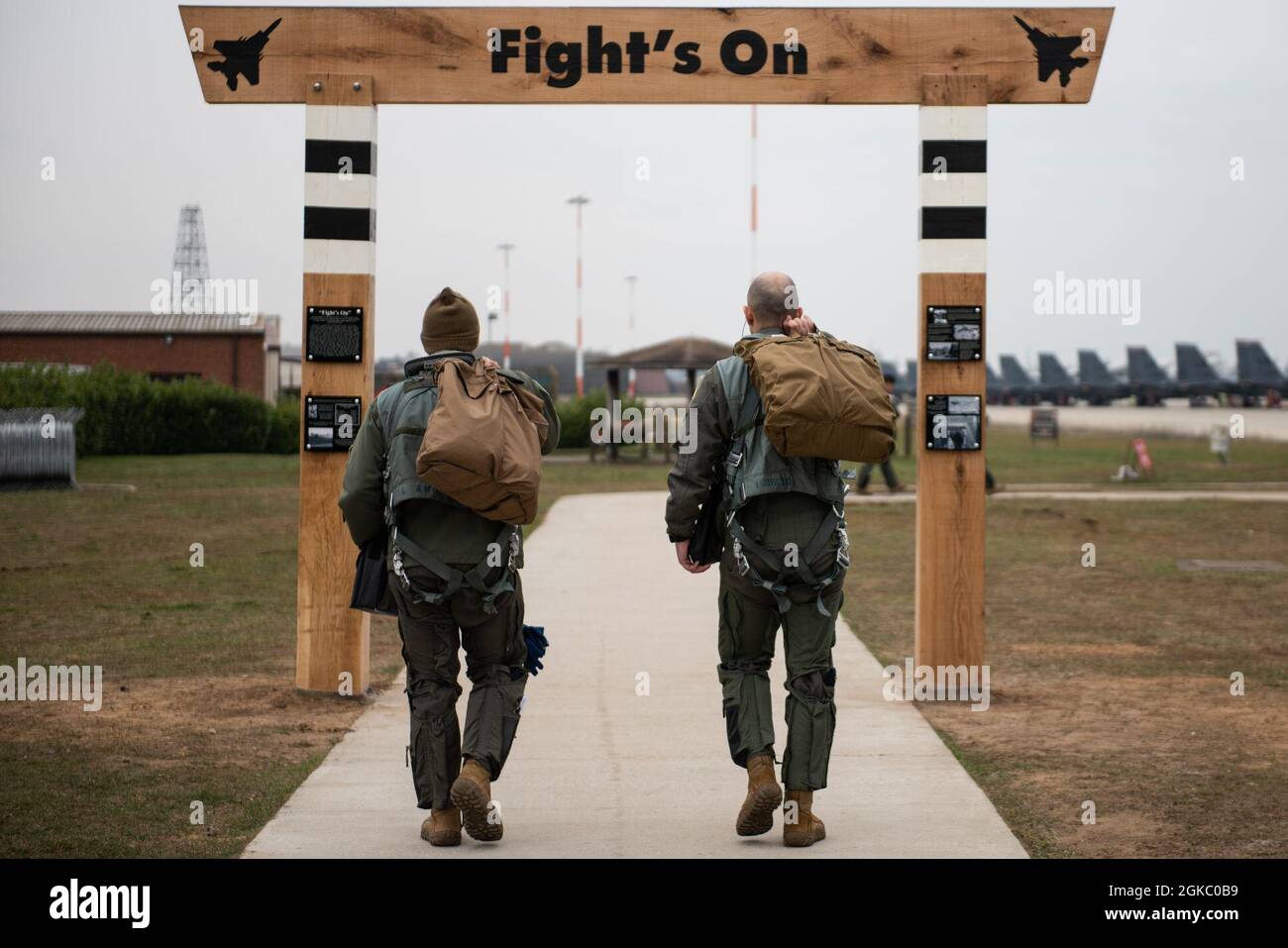 Aircrew assigned to the 494th Fighter Squadron step through the NEW heritage arch on their way to their aircraft at Royal Air Force Lakenheath, England, March 8, 2021. Liberty Wing aircrew and Airmen will walk under this arch on their way to carry out the 48th Fighter Wing mission for years to come. Stock Photo