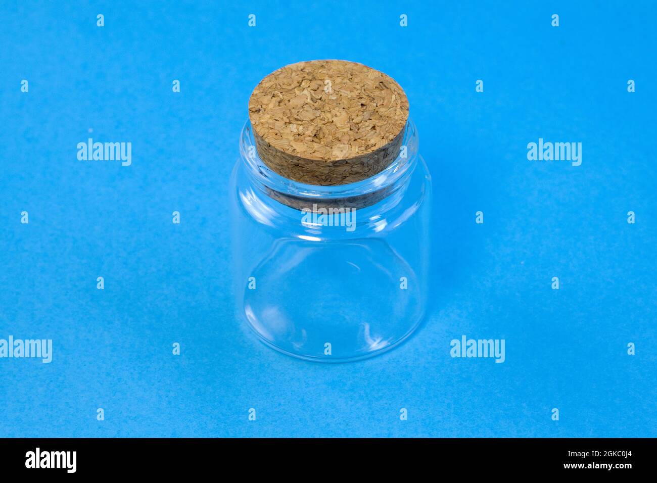 Empty little bottles with cork stopper on blue background front view Stock Photo