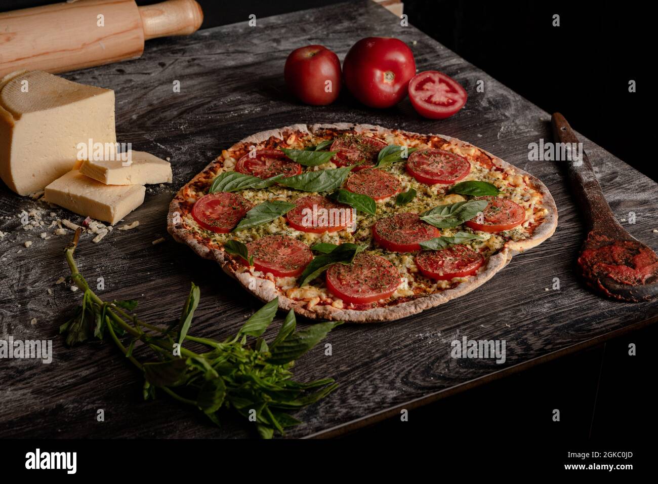 Closeup shot of a delicious pizza with gourmet toppings and ingredients on  a wooden board Stock Photo - Alamy