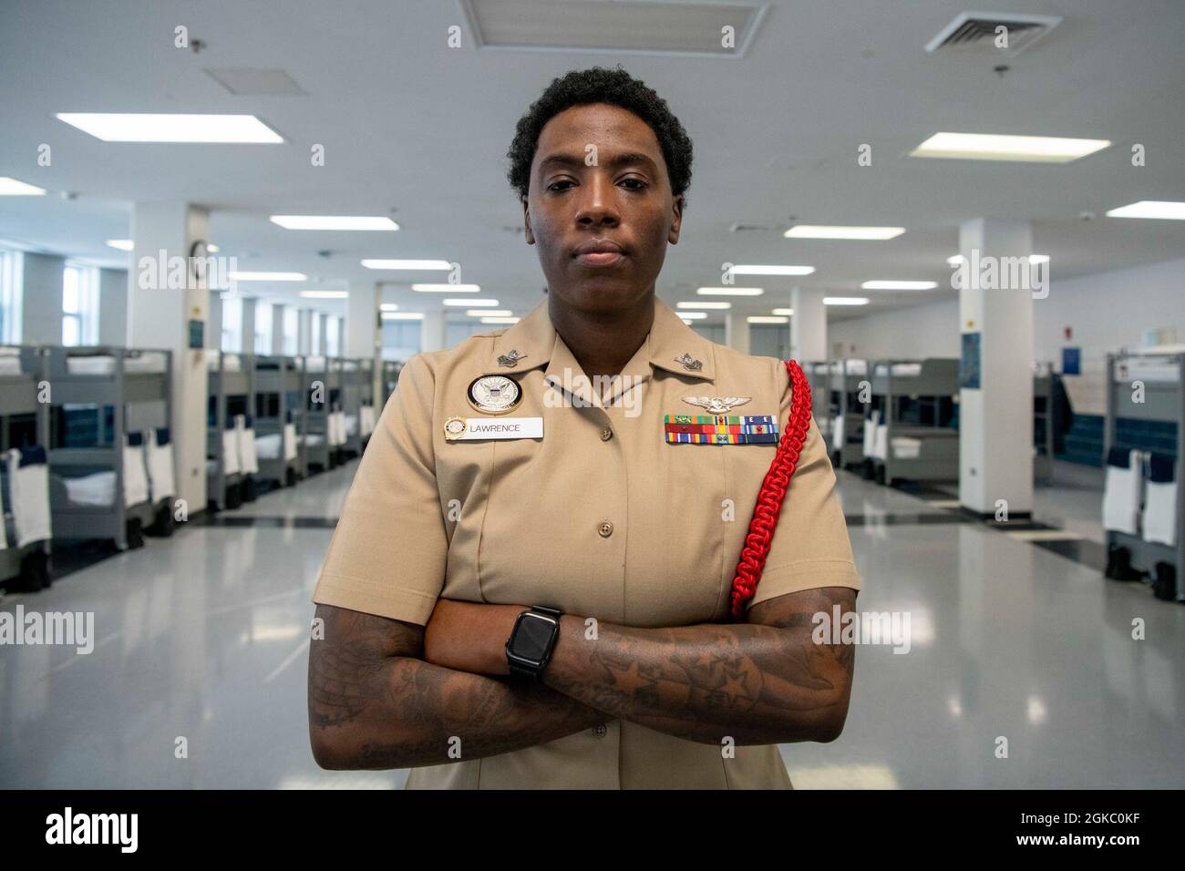 Aviation Machinist’s Mate 1st Class Latasha Lawrence, a recruit division commander, poses for a portrait inside the USS Triton recruit barracks at Recruit Training Command. More than 40,000 recruits train annually at the Navy’s only boot camp. Stock Photo
