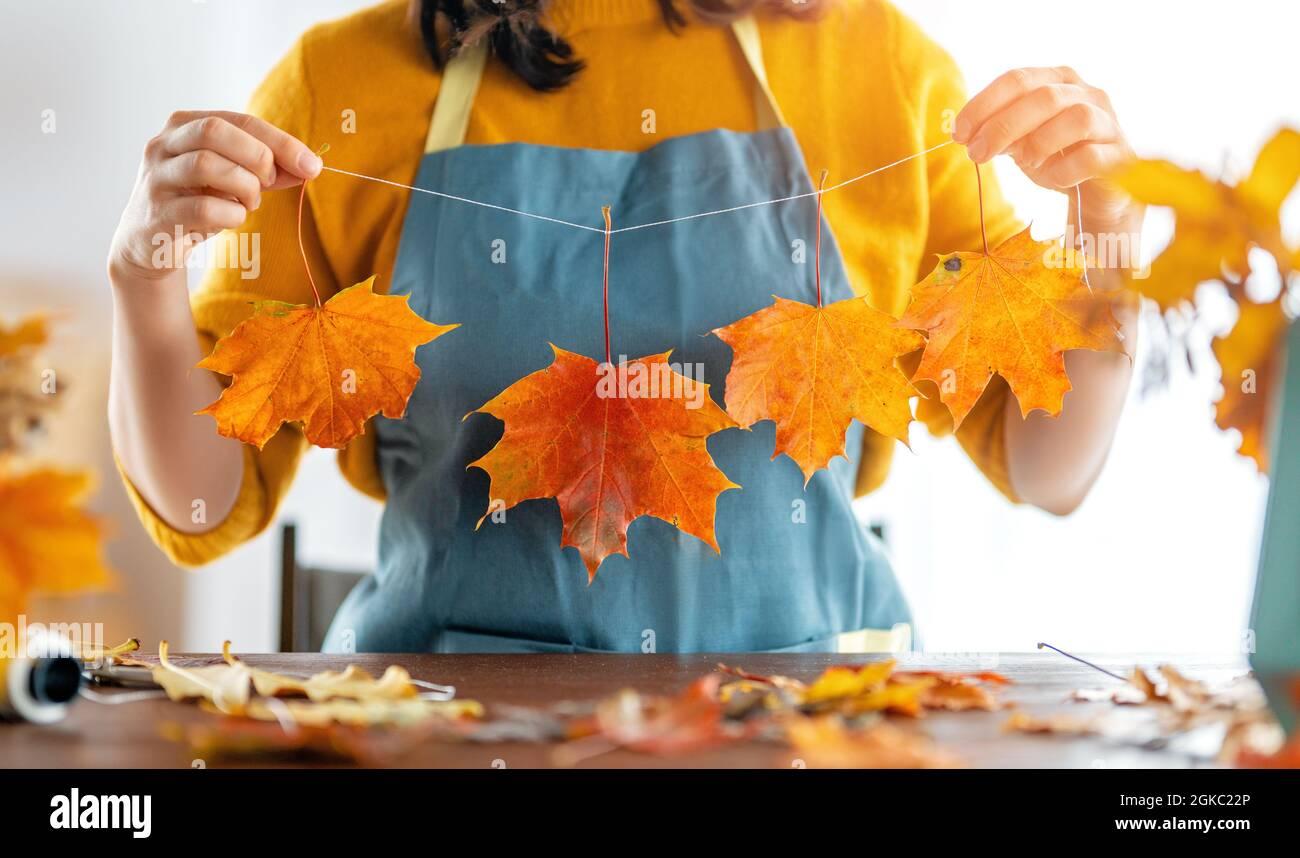 Woman doing autumn decor. Fall atmosphere Stock Photo