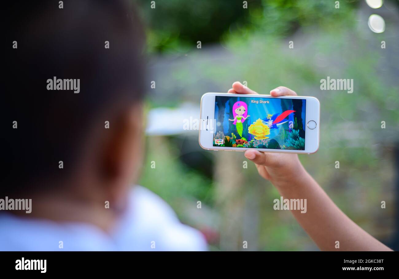 Small baby watching a cartoon on a mobile phone, parents using mobile videos to stop babies cry. The concept of developing childhood learning. Girl Ho Stock Photo - Alamy Small baby watching a cartoon on a mobile phone, parents using mobile videos to stop babies cry. The concept of developing childhood learning. Girl Ho Stock Photo - Alamy