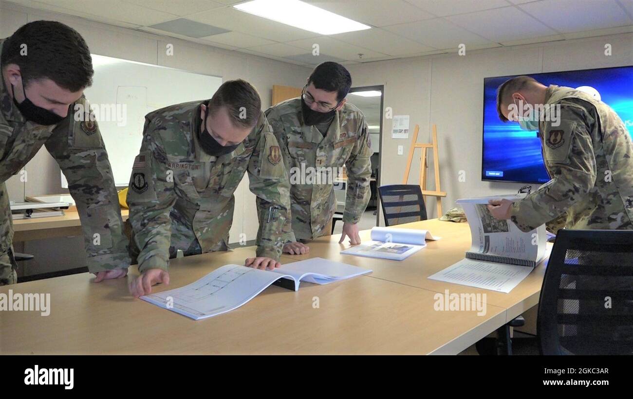 Second lieutenants with the Tyndall Hands program look over planning  documents in the program management office at Tyndall Air Force Base,  Florida. The program is a prototype to allow new Air Force