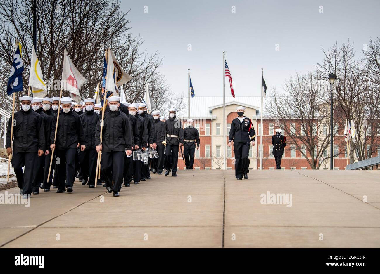 Aviation Ordnanceman 1st Class Sarah Minnick, a recruit division commander, marches alongside her recruit division at Recruit Training Command. More than 40,000 recruits train annually at the Navy’s only boot camp. Stock Photo