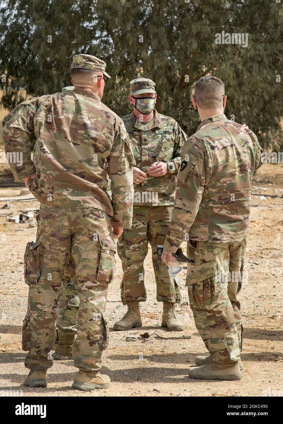 Lt. Col. Christopher Winnek, Task Force Spartan G6, speaks with soldiers during a visit to the King Faisal Air Base in Jordan, Mar. 9, 2021. The soldiers were taking a tour of the air base for future planning purposes. Stock Photo
