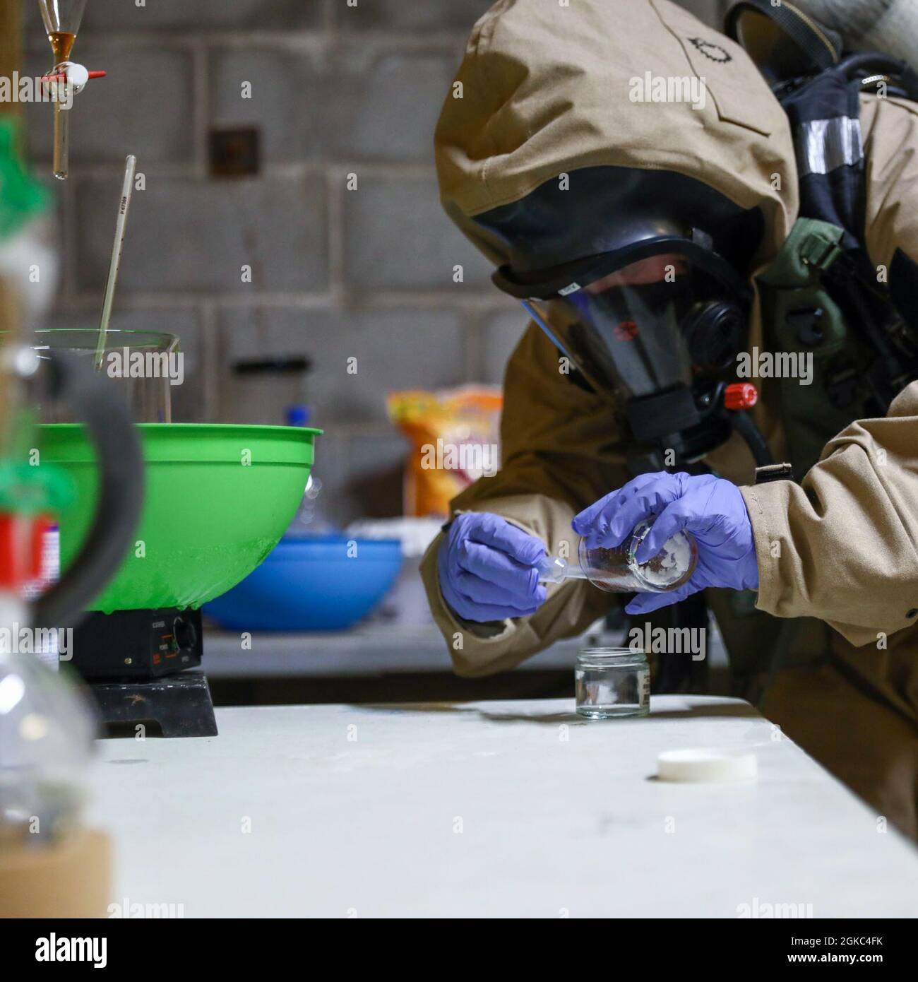 U.S. Marine Corps Lance Cpl. Zoe Privette, a Chemical, Biological, Radiological and Nuclear (CBRN) defense specialist with CBRN Defense Platoon, 1st Marine Division, takes a sample at the Guardian Centers training facility in Perry, Georgia, March 9, 2021. The CBRN Marines conducted a two-week course that allows them to detect, identify and mitigate or neutralize CBRN threats and receive hands-on training with hazardous materials, simulating real world threats in a controlled environment. Stock Photo