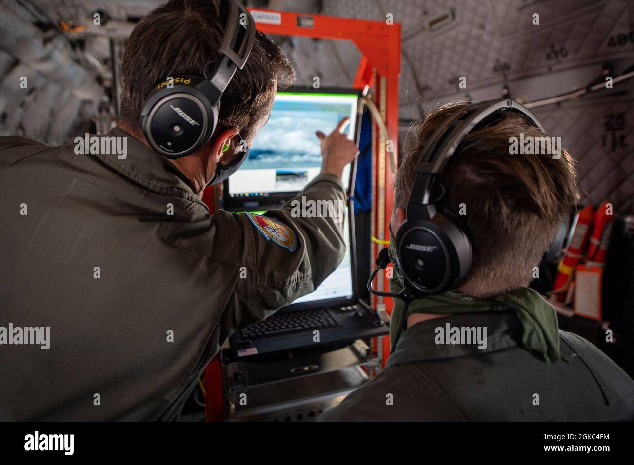 Coast Guard Air Station Sacramento C-27J Spartan crew members navigate the aircraft camera system during a flight from Oakland to San Diego, March 9, 2021. The vaccines were sent from Base Alameda to Sector San Diego to be distributed among Coast Guard personnel in the San Diego area. Stock Photo