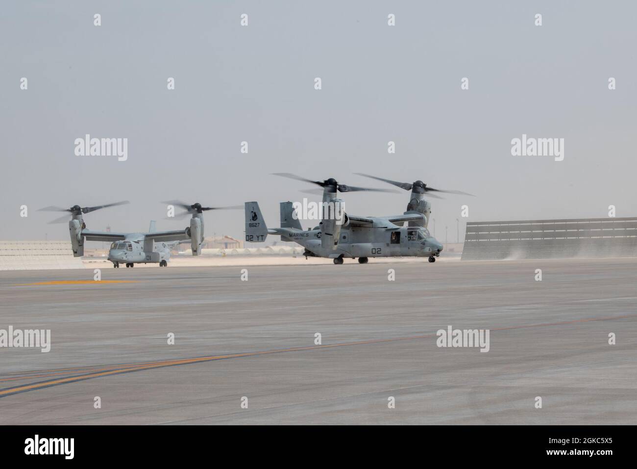 Two U.S. Marine Corps MV-22 Osprey aircraft, attached to Marine Medium Tiltrotor Squadron 164 (Reinforced), 15th Marine Expeditionary Unit, land for refueling operations at Al Udeid Air Base, Qatar, March 2, 2021. The 15th MEU is one of many joint partners in U.S. Central Command’s area of responsibility ensuring regional stability and protection of United States assets and coalition partners.  The MV-22 Osprey participated in the Air Forces Central Agile Combat Employment capstone event. The capstone event enhanced theater ACE competencies, validating operational capabilities and command and Stock Photo