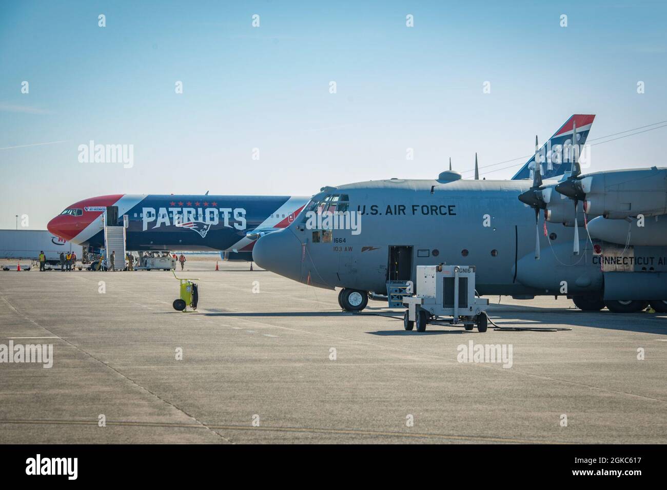 A Boeing 767300ER is parked next to a 103rd Airlift Wing C130H