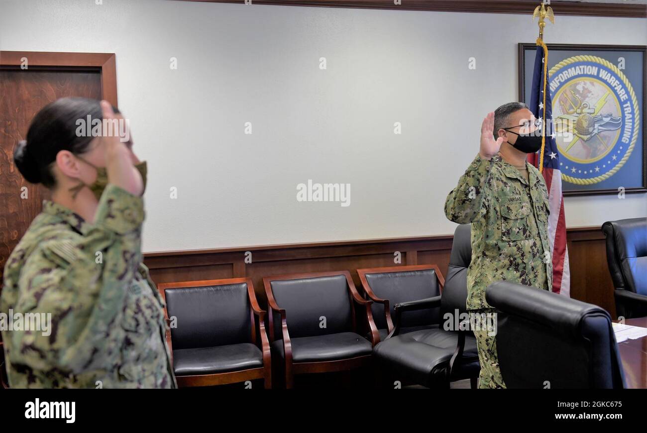 210310-N-XX139-0027 PENSACOLA, Fla. (March 10, 2021) Center for Information Warfare Training (CIWT) Command Master Chief Francisco Vargas (right) and Chief Operations Specialist Kim Meeks reaffirm their oaths of enlistment during a stand-down virtually to address extremism in the ranks as ordered by Secretary of Defense Lloyd Austin and in compliance with Acting Secretary of the Navy Thomas Harker and Chief of Naval Operations Adm. Mike Gilday. The stand-down was intended to be the first step to address extremism in the ranks, and thoughtful reflection and candid discussions were led by CIWT’s Stock Photo