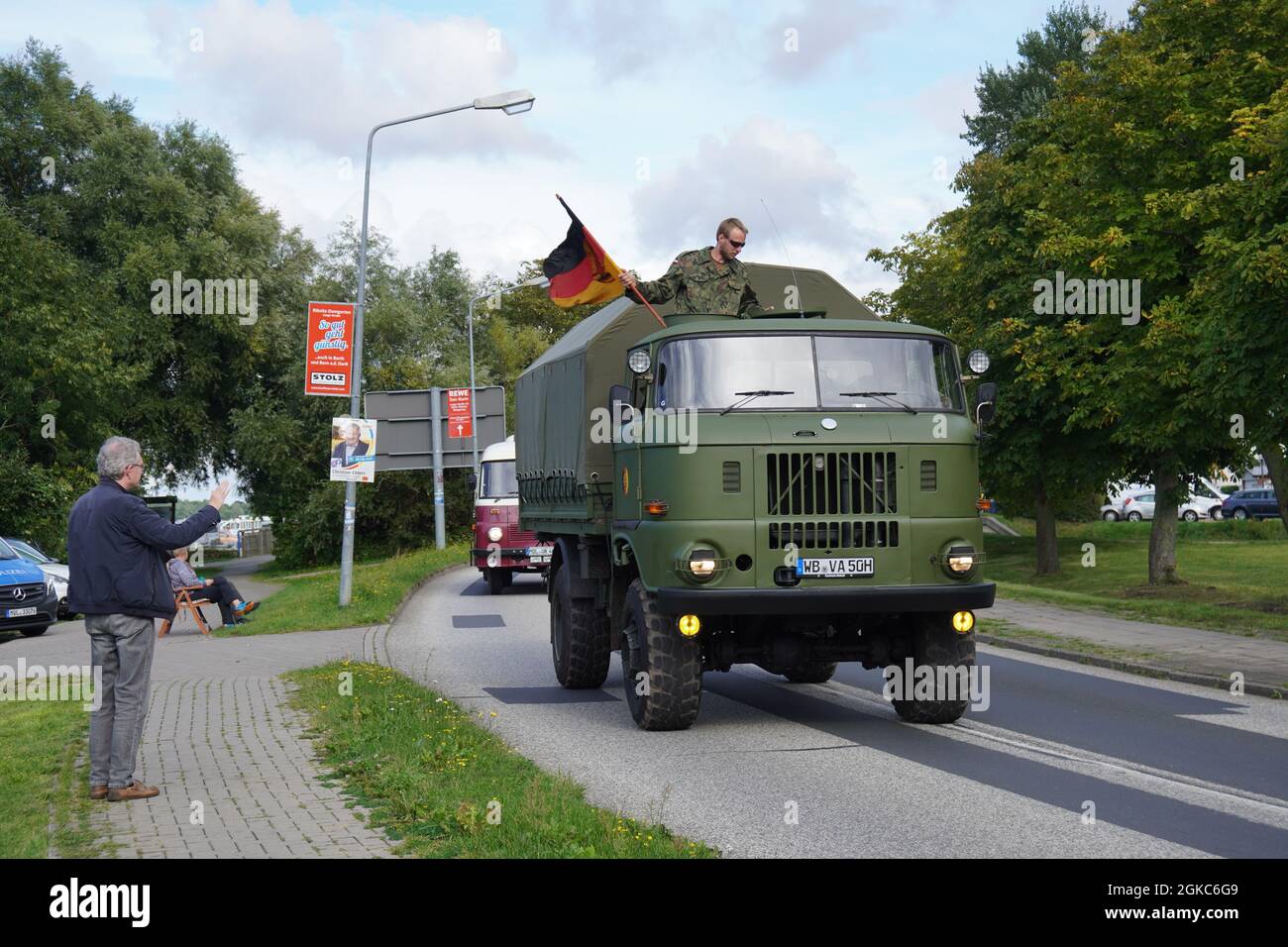 RIBNITZ DAMGARTEN, GERMANY - Aug 27, 2021: A large military truck with a German flag driving through a road in Ribnitz Damgarten, Germany Stock Photo