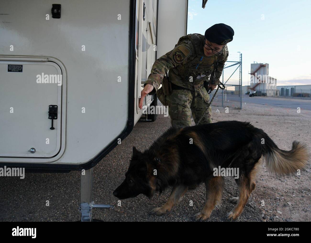 U.S. Air Force Staff Sgt. Tara C. Cummins, 377th Security Forces Squadron military working dog (MWD) handler, and MWD Hugo perform vehicle inspections on Kirtland Air Force Base, New Mexico, March 9, 2021. Cummins has been a dog handler for four years and Hugo is the third MWD she has worked with. Stock Photo