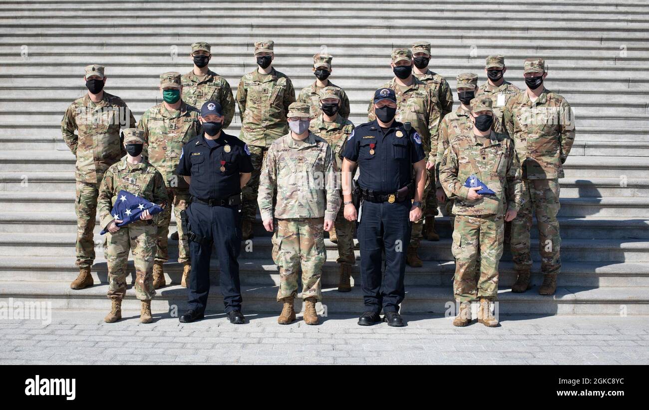 U.S. Soldiers with the Michigan National Guard pose for a photo with U.S. Capitol Police officers at the U.S. Capitol in Washington, D.C., March 10, 2021. Approximately 1000 Soldiers returned home to Michigan after supporting Operation Capitol Response II at the request of the National Guard Bureau and Capitol Police. Stock Photo