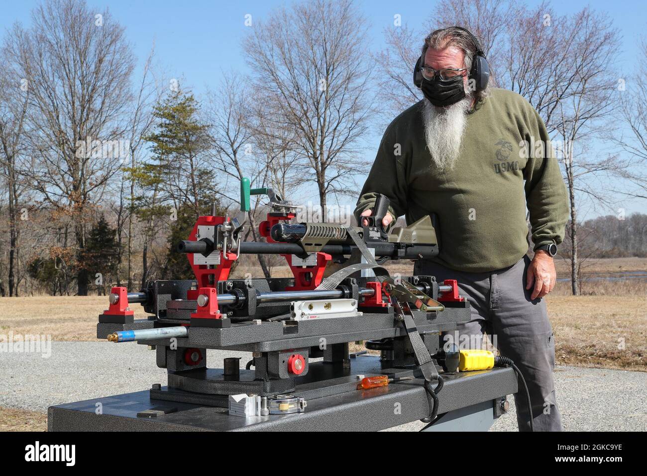 210310-N-CM812-210, Naval Surface Warfare Center Indian Head Division Explosive Ordnance Disposal (EOD) Technology Assessment Branch Lead Test Engineer Keith Chamberlain fires an Umarex Hammer air rifle, March 10. This test was performed to evaluate the capability of commercial-off-the-shelf air rifles to meet a naval EOD need for a non-pyrotechnic means of safely disrupting specific in-theater threats. The test captured the velocity, consistency, and penetration capabilities of a series of .50 caliber projectiles fired by the Umarex Hammer and AirForce Texan air rifles. Stock Photo