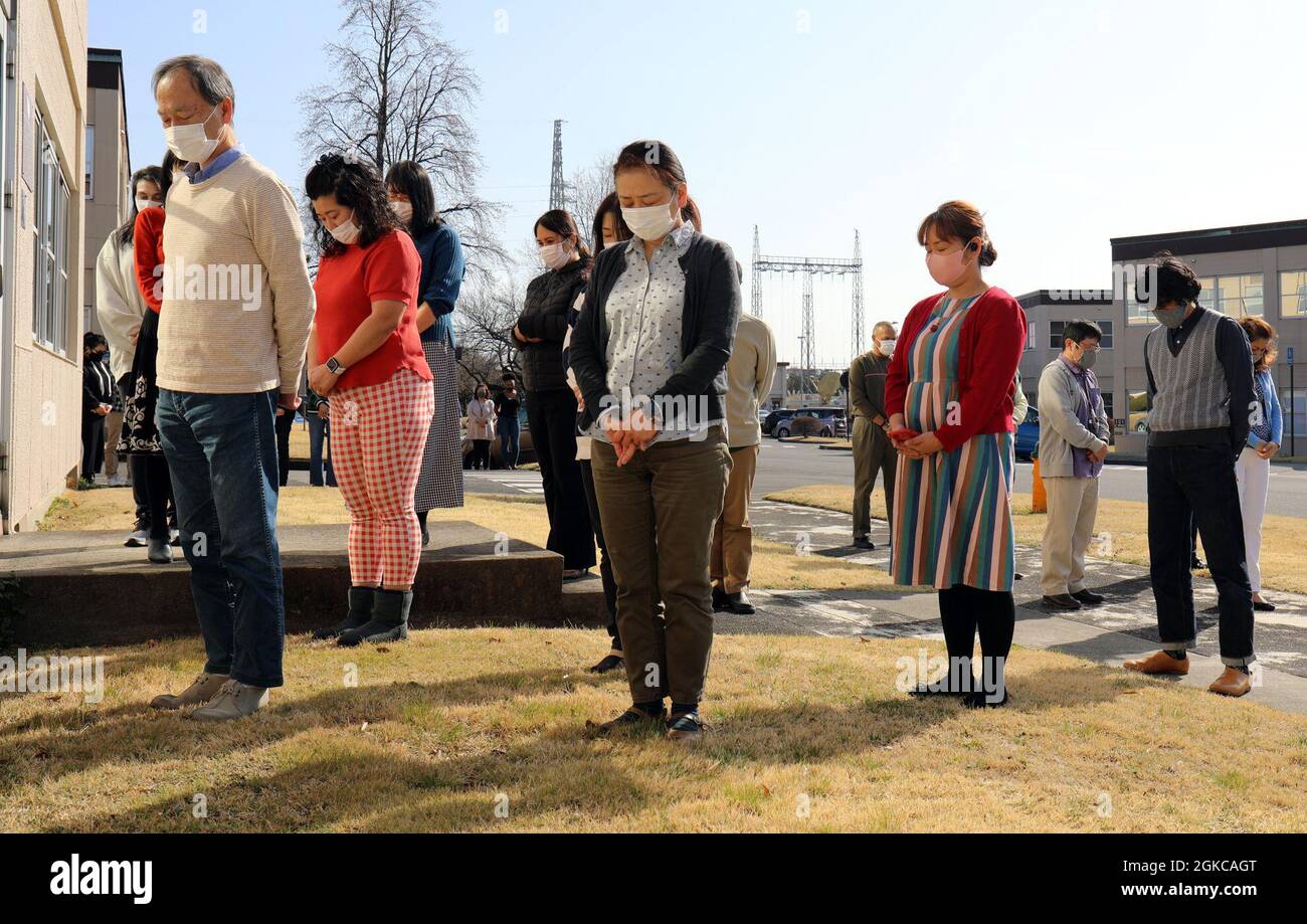 U.S. Army Garrison Japan employees stand outside the headquarters building at Camp Zama, Japan, at 2:46 p.m. March 11, in commemoration of the magnitude 9.0 earthquake that struck off the eastern coast of Japan 10 years ago. Stock Photo