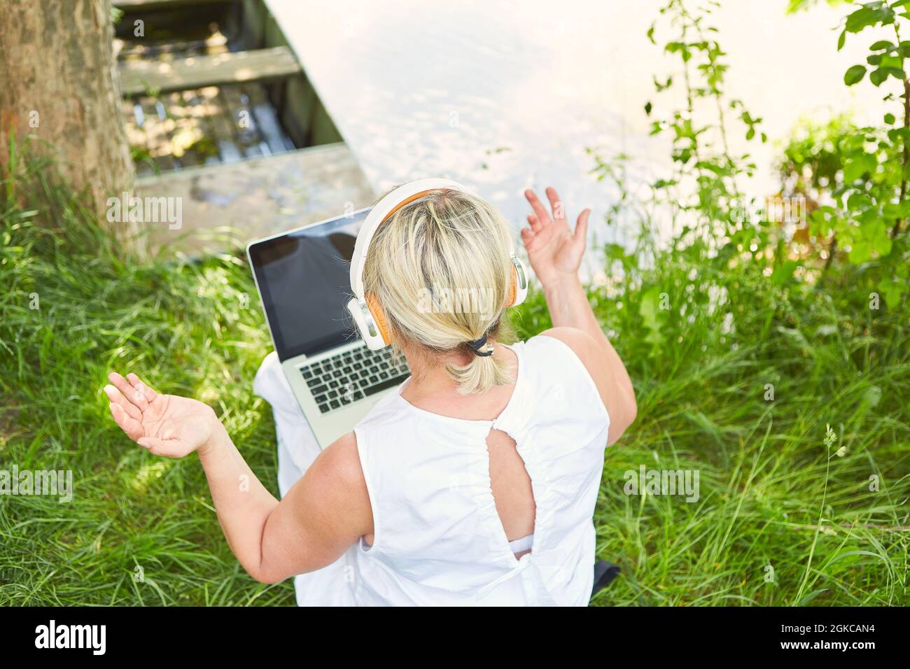 Woman as a freelancer on laptop PC online while video chat in nature in summer Stock Photo