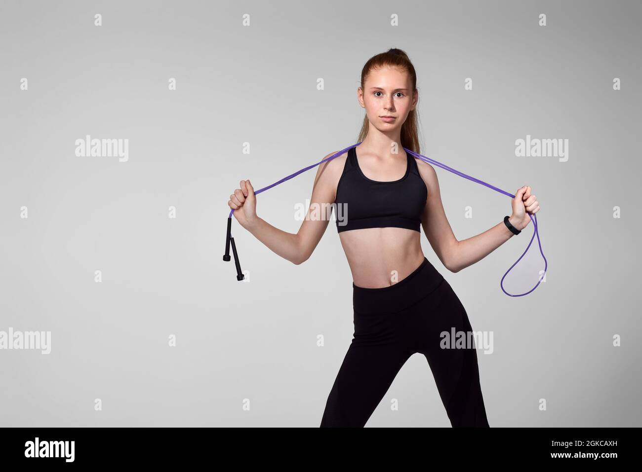 Woman holding jumping rope hi-res stock photography and images