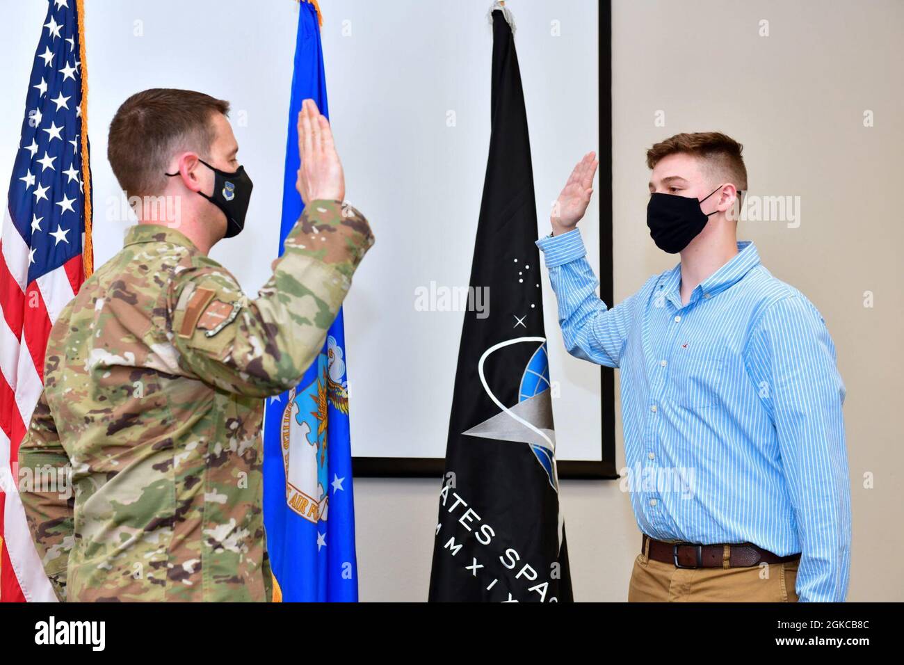 Col. John Schutte, 19th Airlift Wing commander, left, gives the Oath of