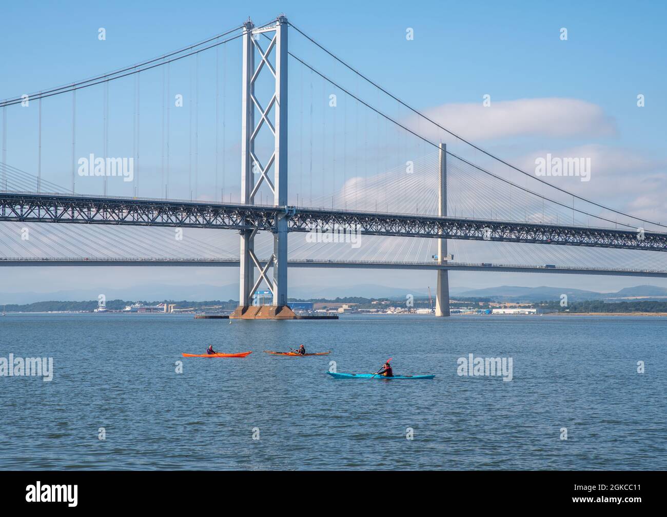 South Queensferry, Edinburgh, Scotland 7th September 2021 - Three  Kayaks passing under the Forth Road Bridges on a sunny day with clear sky. Stock Photo