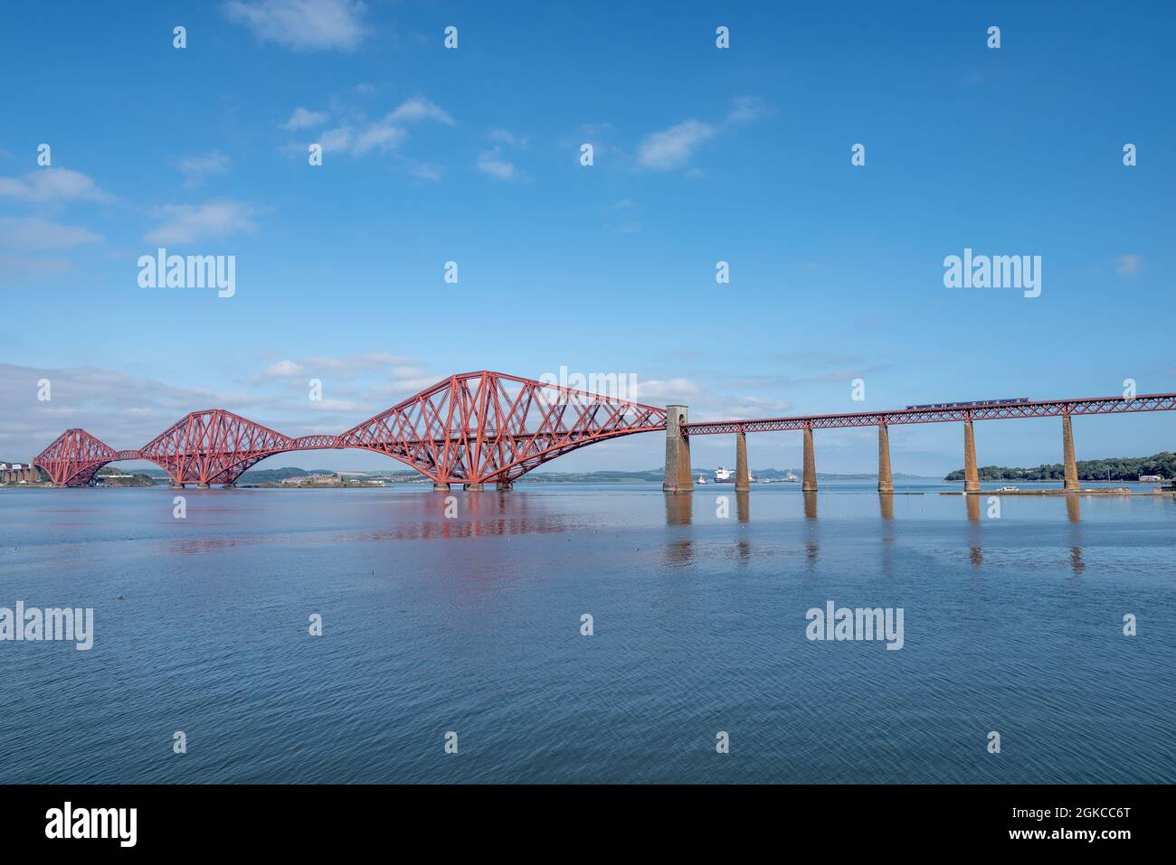 South Queensferry, Edinburgh, Scotland 7th September 2021 - A train passing over the Forth Bridge on a brigh sunny day with blue sky Stock Photo