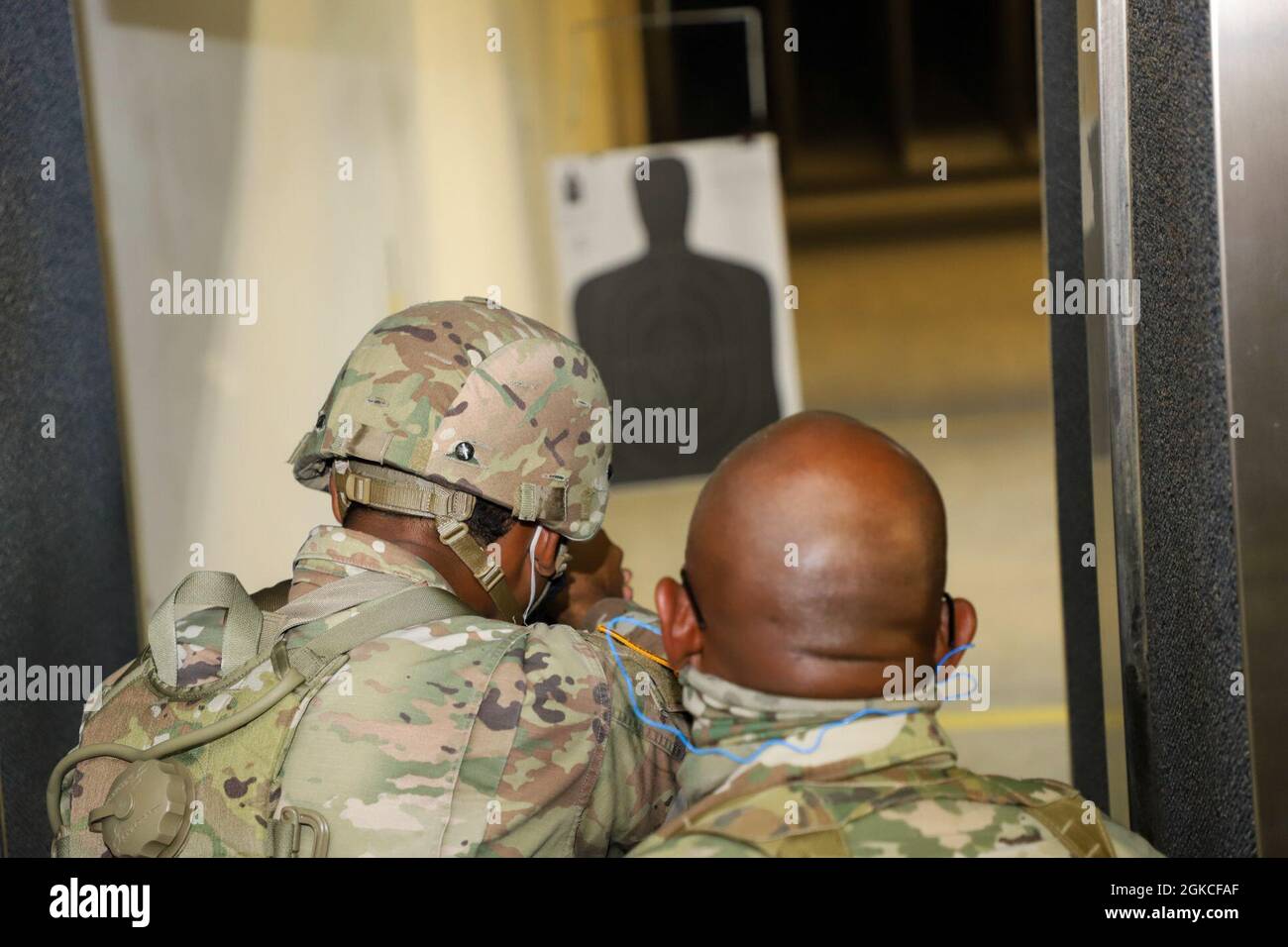 Pfc. Eddison Lewis (left) alongside Master Sgt. Louin Chung (right) is firing an M9 weapon at the range qualification segment in D&J Shooting Gallery during the Best Warrior Competition, St. Croix, March 12, 2021.    The VING BWC is a culminating test where the competing NCOs and soldiers spend five days competing in various challenges, including firing weapons, land navigation, the Army Physical Fitness Test, and other various events. These challenges will test each competitor's knowledge, technical and tactical skills, physical endurance, mental toughness, and overall combat readiness. Stock Photo