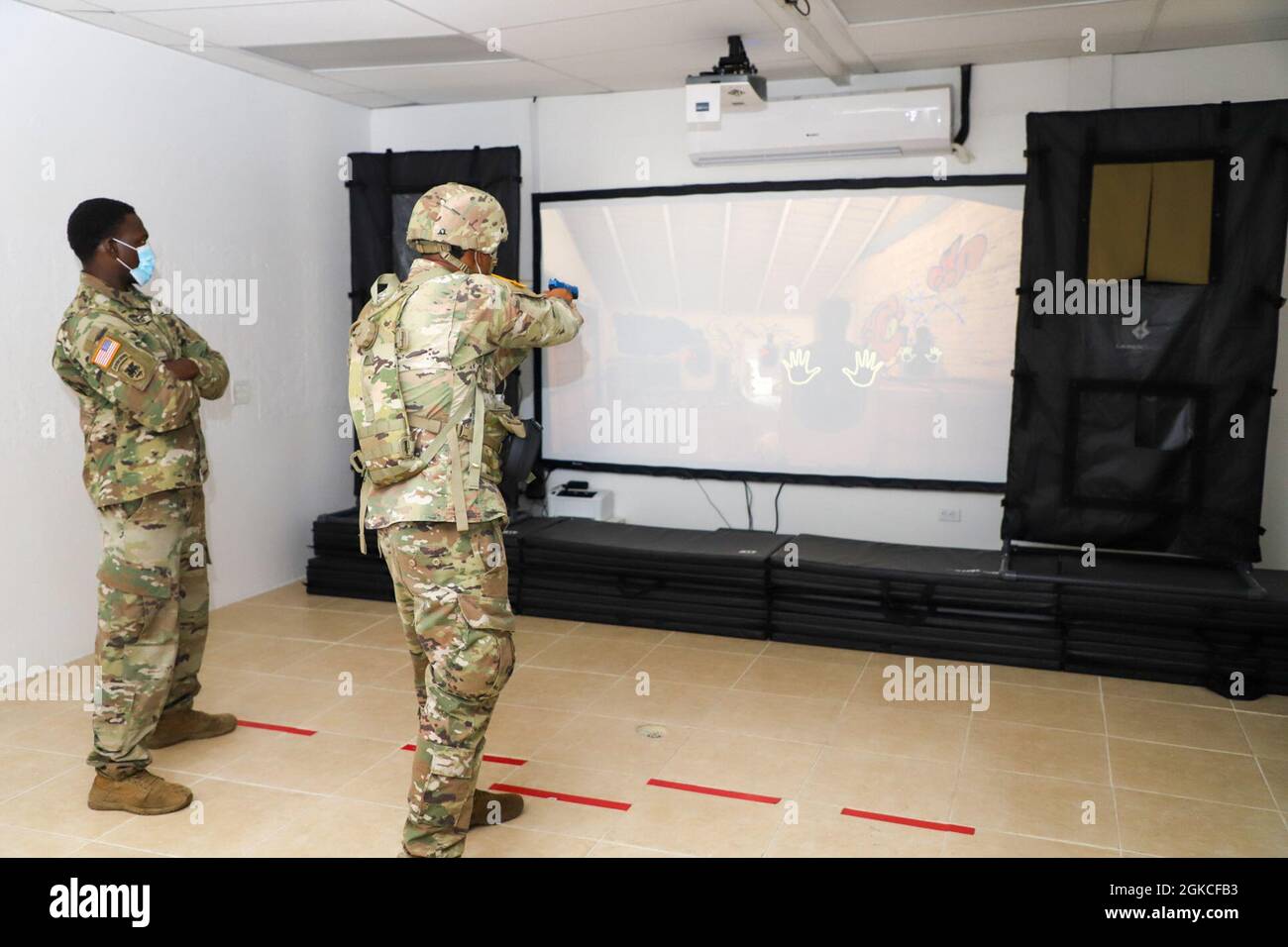 Pfc. Eddison Lewis (right) alongside Sgt. 1st Class Raynard Francis (left) conducting a virtual simulation mystery event at D&J Shooting Gallery during the Best Warrior Competition, St. Croix, March 12, 2021.    The VING BWC is a culminating test where the competing NCOs and soldiers spend five days competing in various challenges, including firing weapons, land navigation, the Army Physical Fitness Test, and other various events. These challenges will test each competitor's knowledge, technical and tactical skills, physical endurance, mental toughness, and overall combat readiness. Stock Photo