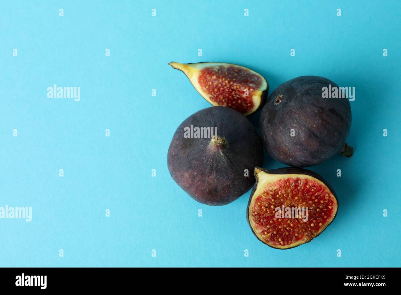 Fig on blue background, space for text Stock Photo