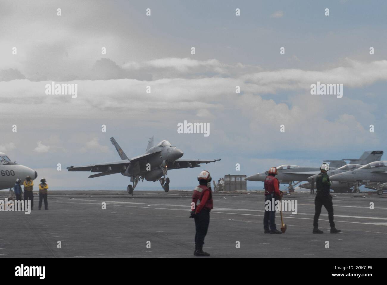 INDIAN OCEAN (March 13, 2021) – An F/A-18E Super Hornet, assigned to the “Golden Warriors” of Strike Fighter Squadron (VFA) 87, lands on the flight deck of the aircraft carrier USS Theodore Roosevelt (CVN 71) March 13, 2021. The Theodore Roosevelt Carrier Strike Group is on a scheduled deployment to the U.S. 7th Fleet area of operations. As the U.S. Navy’s largest forward-deployed fleet, 7th Fleet routinely operates and interacts with 35 maritime nations while conducting missions to preserve and protect a free and open Indo-Pacific Region. Stock Photo