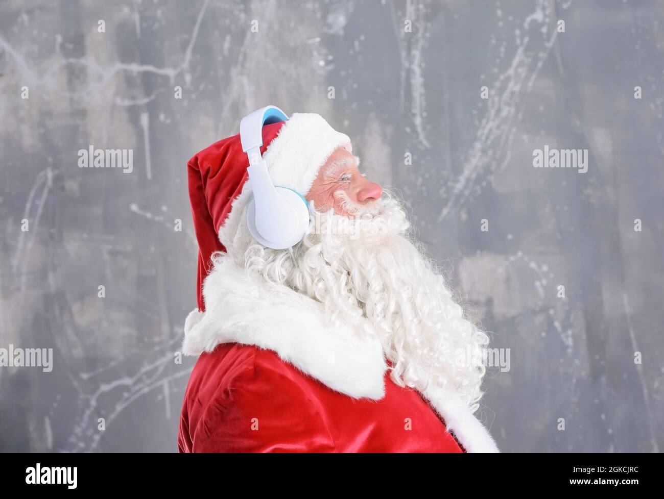 Santa Claus listening to music on grunge background Stock Photo - Alamy